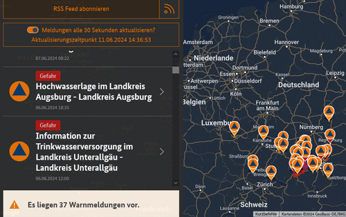 Ein Screenshot der Notfall-Informations- und Nachrichten-App des Bundes, kurz Warn-App NINA. Links ist ein Ticker mit aktuellen Warnungen zu sehen, rechts eine Landkarte dazu.