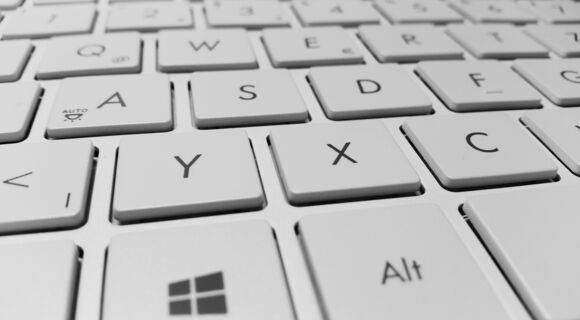 Der Ausschnitt einer hellen Tastatur ist zu sehen. Im Fokus ist die Windows-Taste.